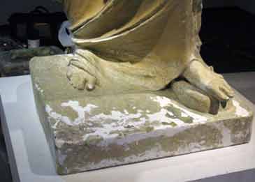 Cracks on large statue being repaired.